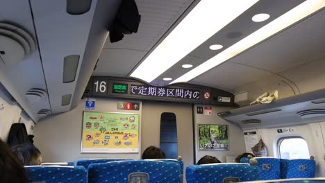 passengers seated in a high-speed train interior