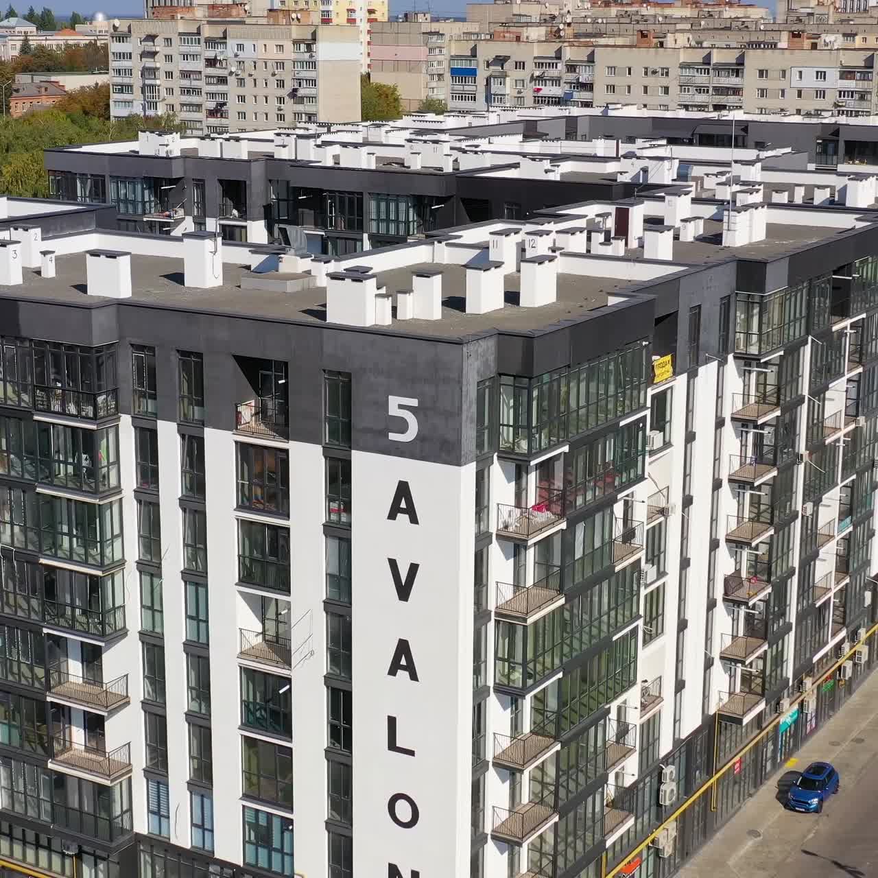 Multi story apartment building. New modern black and white apartment building in the city