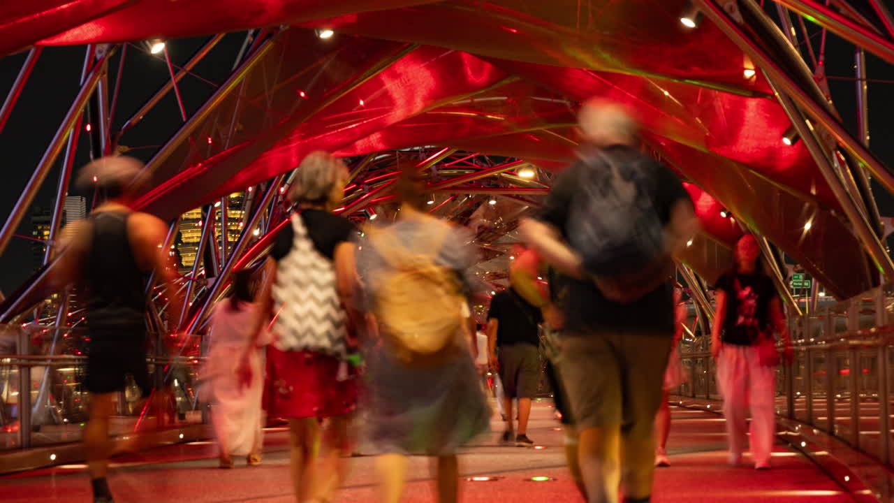 SINGAPORE - 5 MARCH 2025 : timelapse of the helix foot bridge in singapore marina bay at night
