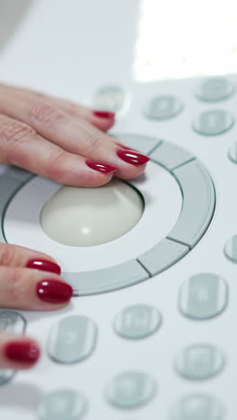 female doctor's hands working on a panel of medical equipment. close up. advanced apparatus for ultra sound check.