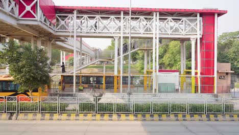 panoramic view of modern metro bus station with overhead pedestrian bridge, showcasing scenic urban infrastructure and transportation hub