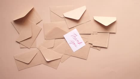 pile of brown envelopes with a thank you note