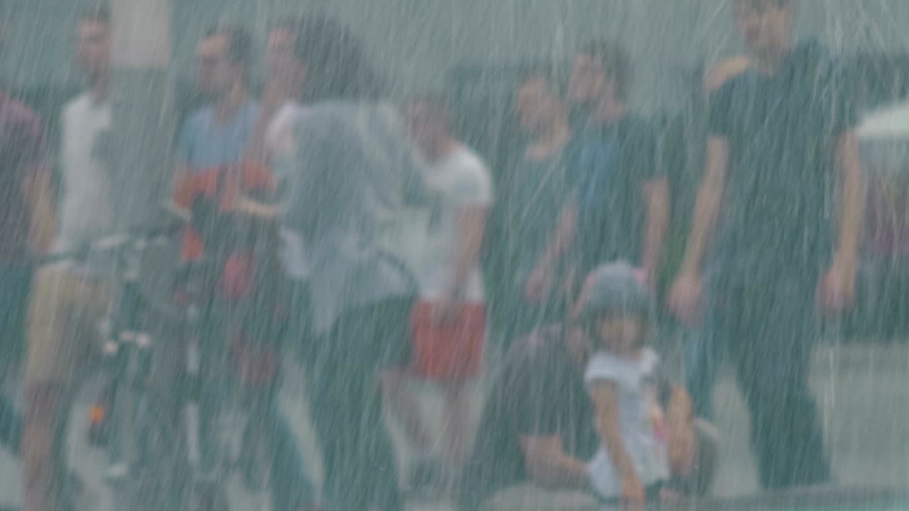 People in the City near Fountain Flow Close-Up, rain effect