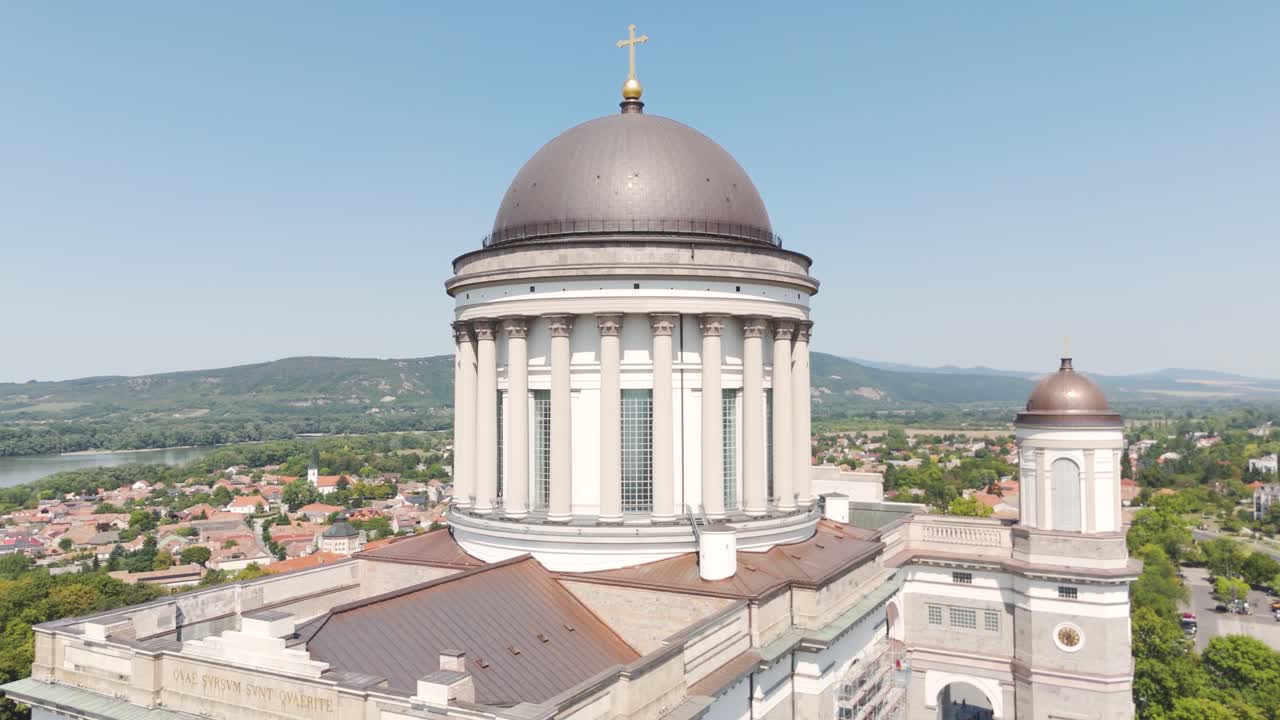 Aerial view of the dome of the Esztergom Basilica, overlooking the Danube River bend and the surrounding landscape in Hungary. Circle Dolly