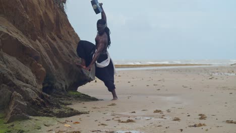 a muscular, dark-skinned man, embodying nekharis in perfect cosplay, enjoys the tropical beach setting