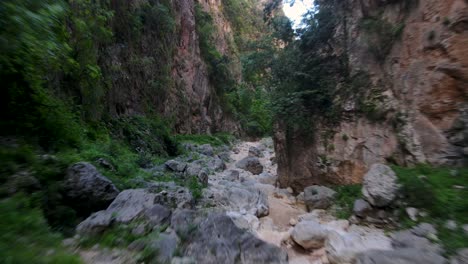 fly over rocks between steep cliffs, gjipe canyon, albania