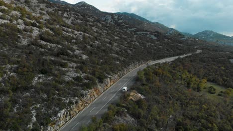 Aerial-drone-shot-over-car-road-located-near-sea-2