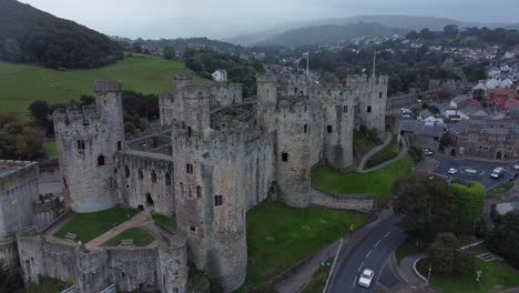 medieval conwy castle walled market town misty mountains aerial view pull away