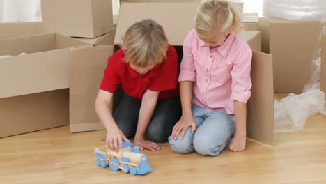 children playing with a train after moving house