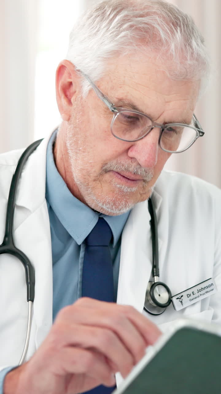 Close-up of Senior Male Doctor Reviewing Medical Information
