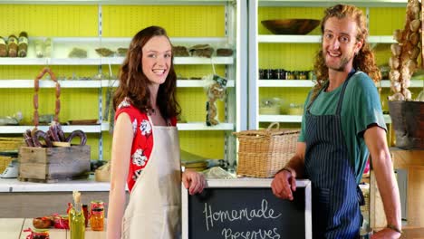 Workers-standing-near-a-chalkboard-at-counter