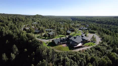 Aerial-view-of-Alaskan-Wilderness-Lodge-among-Green-trees-in-Denali-State-Park