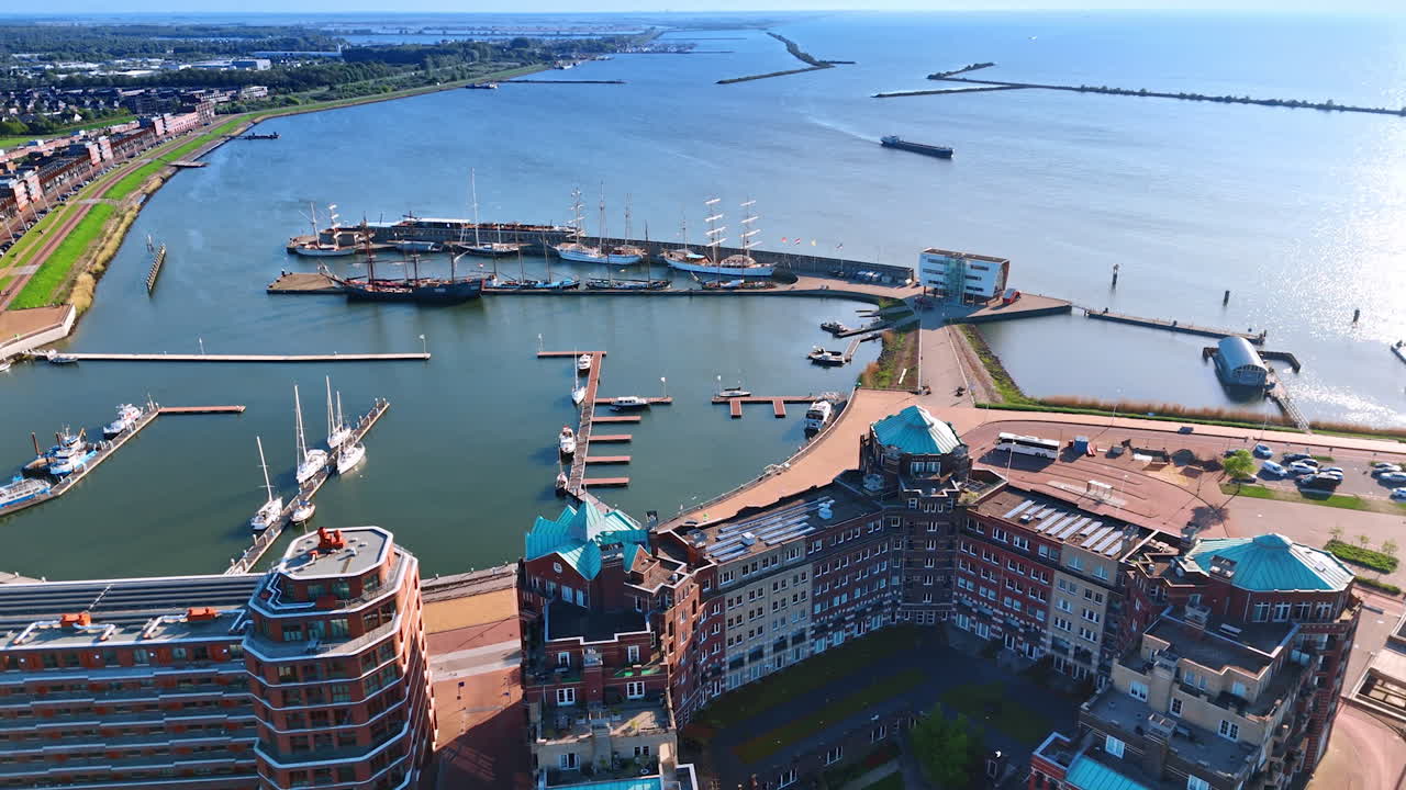 Beautiful design buildings near the port of Lelystad, the Netherlands. Aerial perspective on the waterscape of Lake Markermeer and green cityscape.