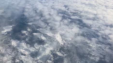 Aerial-Above-Clouds-of-Snowy-Mountain-Ranges-in-Montana