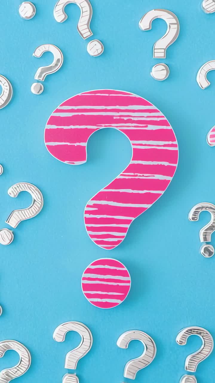 Vertical video: Showing pink question mark on turquoise backdrop with white question marks