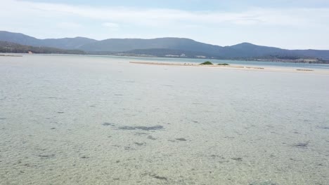 rotating done footage over shallow water mountains in background