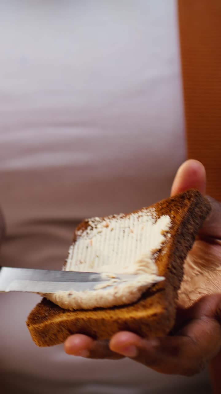 Vertical Video Close up, cream cheese spread, toast bread, african american vlogger