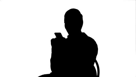 silhouette young woman surgeon doctor reading sms on cell phone