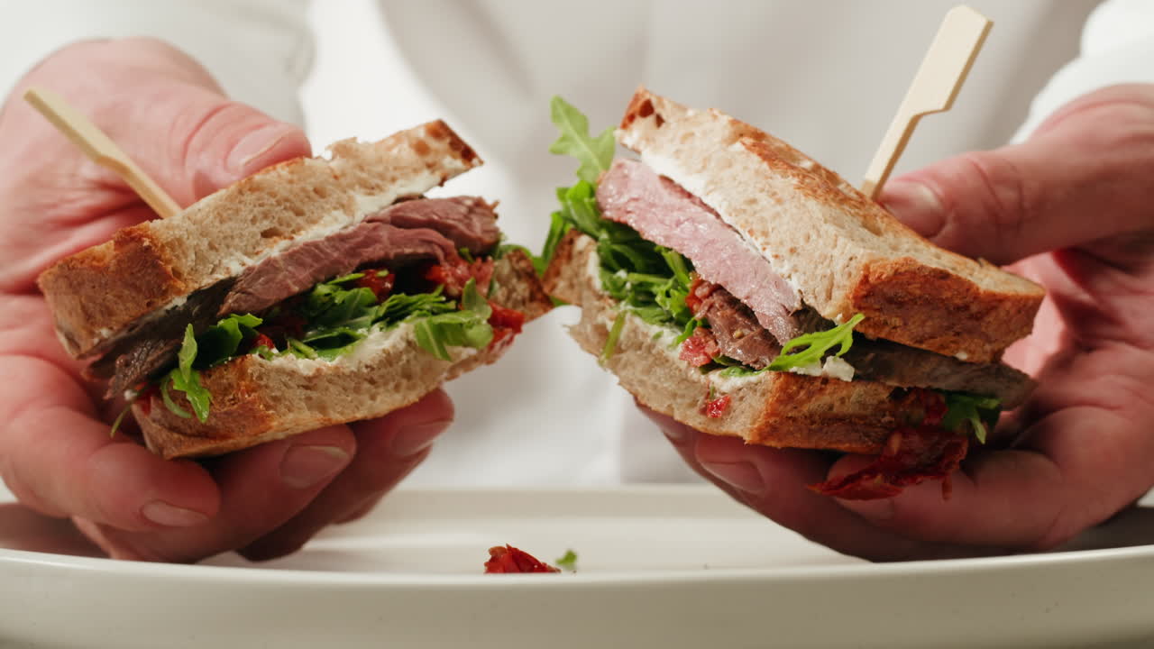 Chef holding a gourmet sandwich