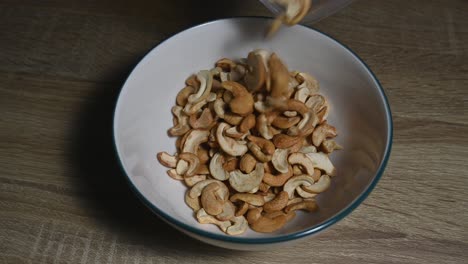 empty bowl then cashew nuts poured in, a healthy source of protein and energy food