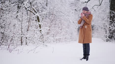 a woman drinks hot tea in the winter forest