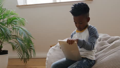 boy using tablet computer at home