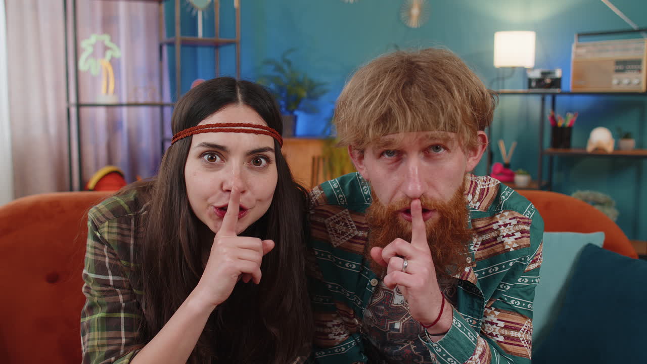 Family man woman presses finger to lips makes silence hush sign do not tells gossip secret quiet