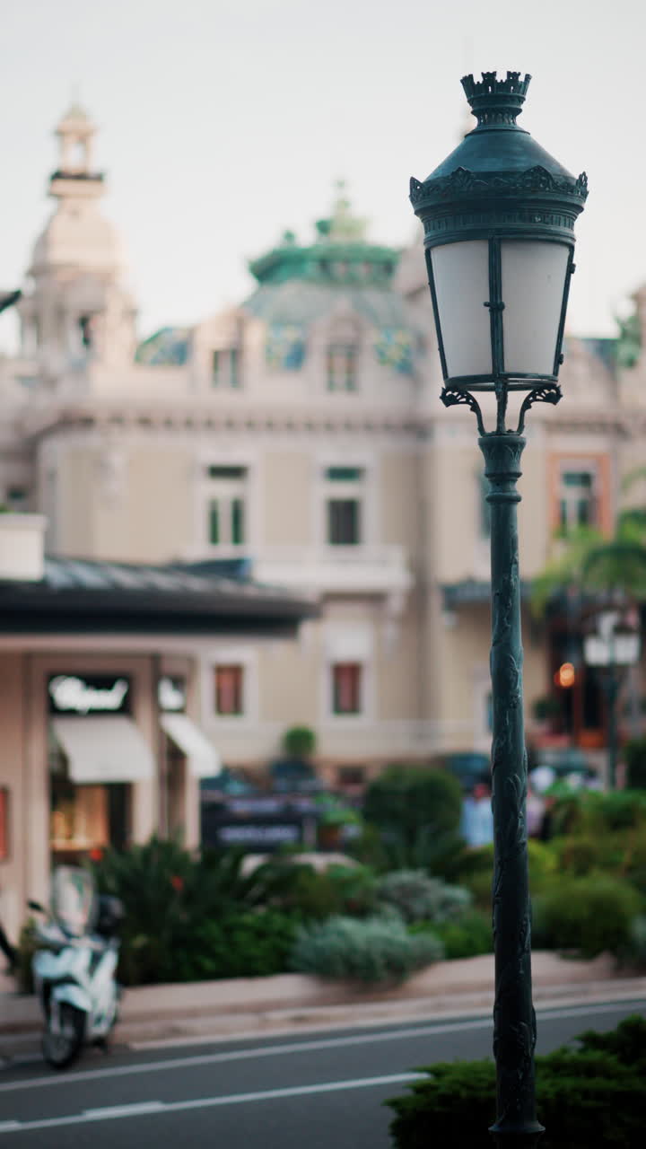 Close up of a street lamp with a blurry city view of Monaco. Vertical