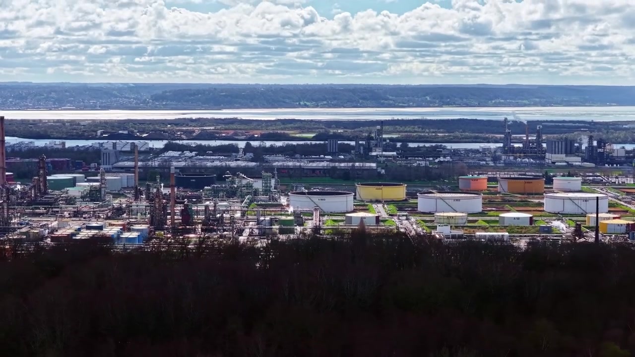 Industrial chemical plant extensive storage facilities forest foreground
