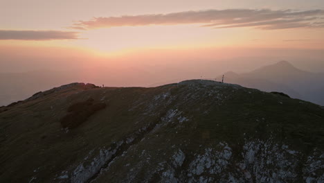 drone shot of the top of mountain peca at the sunrise in the morning, hiker walking on the ridge of the mountain