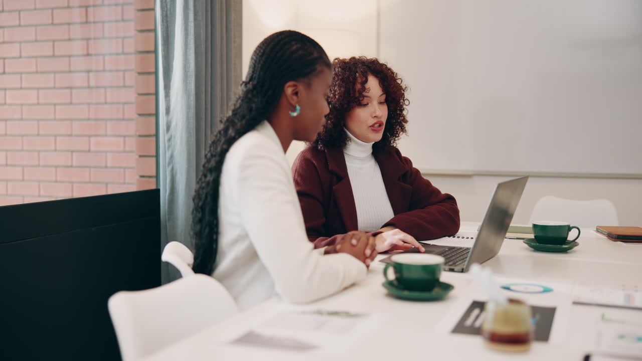 Two Businesswomen Meeting at a Desk