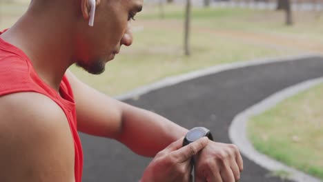 side view man with prosthetic leg looking at his watch