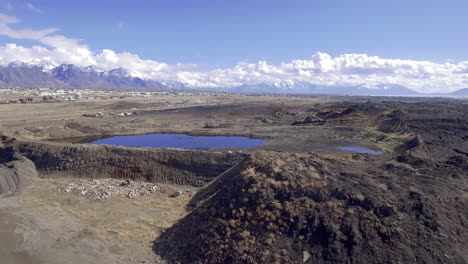 a drone captures images while flying by the old geneva steel production catch pond and slag heap.