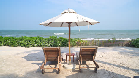 umbrella with bed pool around swimming pool with ocean sea background - holiday and vacation concept