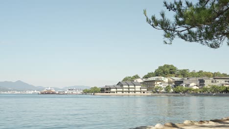 itsukushima island in hiroshima captivates with its tranquil shoreline, vibrant greenery, and iconic cultural landmarks.