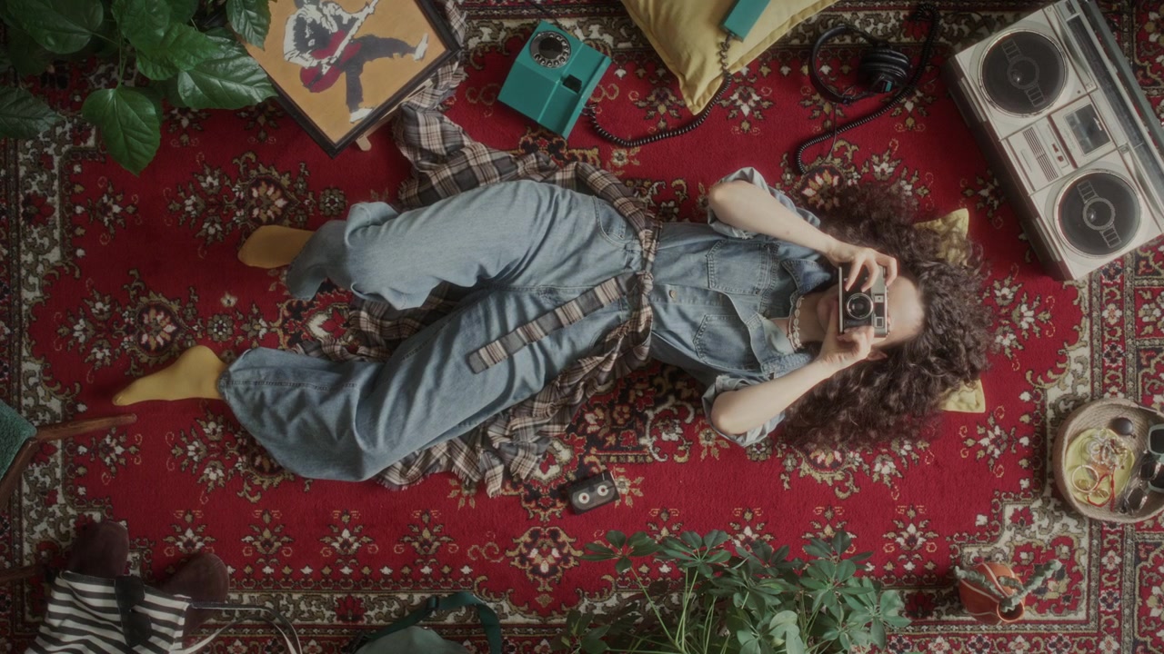 Directly Above of Girl Taking Picture with Retro Film Camera on Vintage Carpet