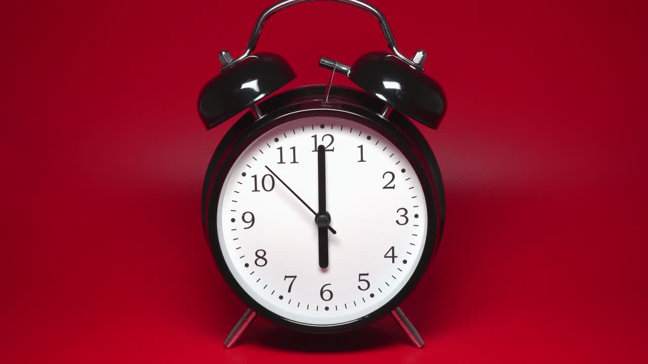 빨간 바탕에 두 개의 종이 있는 검은색 빈티지 알람 시계