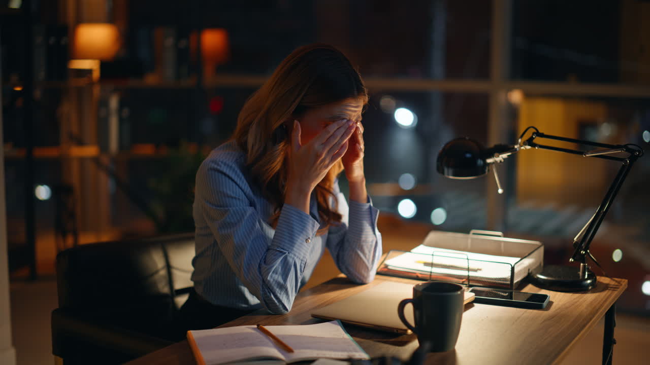 Exhausted entrepreneur thinking deadline sitting night workplace closeup