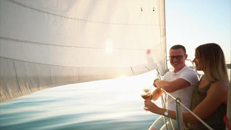 couple enjoying a romantic sunset sailing trip