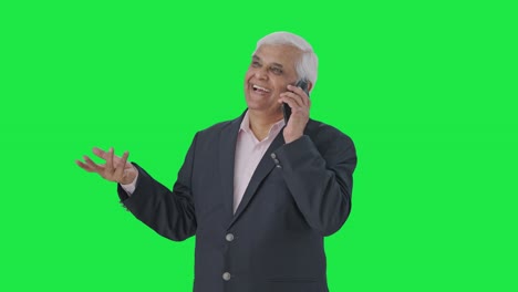 Happy-Indian-senior-manager-talking-on-phone-Green-screen