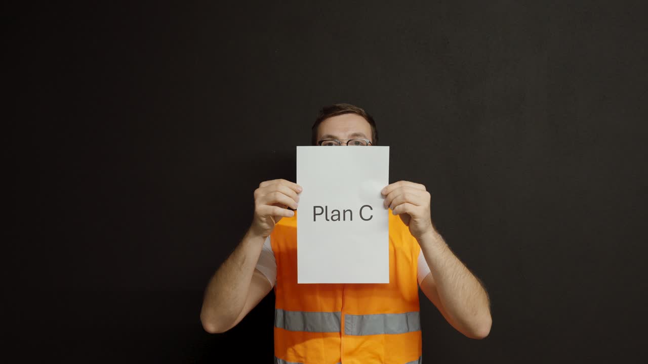 A worker in a reflective vest throws away Plan A and Plan B, then confidently holds up Plan C, symbolizing finding the right solution after several attempts