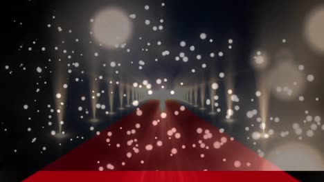 digital composite video of golden glowing spots moving against red carpet with lights flashing