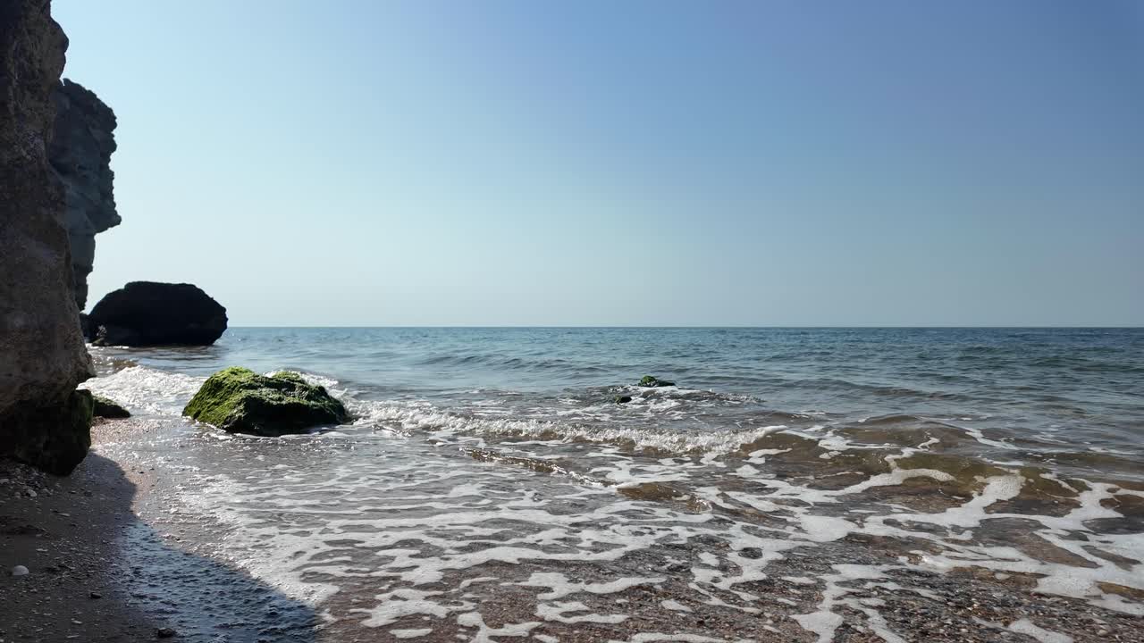 Serene Seascape: Waves Crashing on Rocky Beach