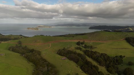 a stunning 4k 60fps aerial view of the sprawling stony batter historic reserve on new zealand's waiheke island, capturing the wwii fortress ruins amidst rolling green hills and rugged coastline