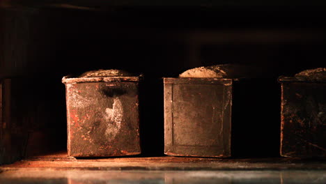 cooking sourdough bread on baking steel inside hot traditional oven - close up, slider shot