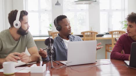 Happy-diverse-male-friends-talking-and-recording-in-living-room