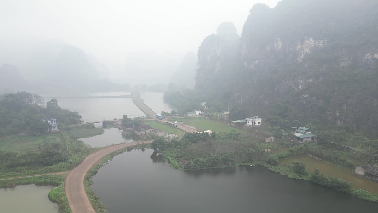 aerial view of road causeway in swamp land in the mountainous region of Ninh Ninh in Northern Vietnam