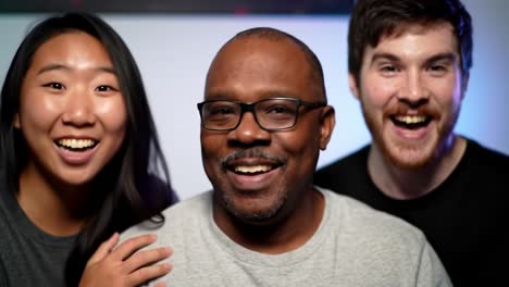 a joyful reunion: three friends share laughter and friendship in a lighthearted moment captured on camera