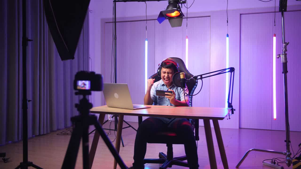 Asian Kid Boy Playing Video Game With Mobile Phone Then Celebrating While Live Stream, Professional Light Equipment