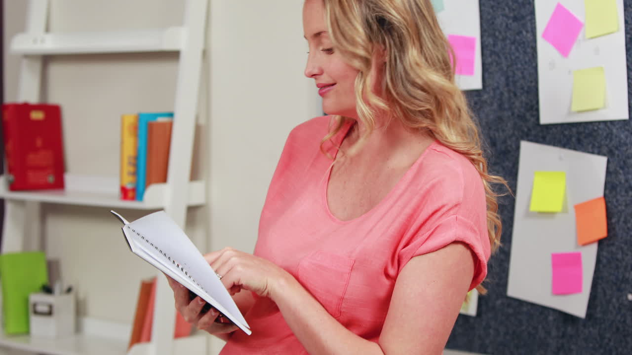 Pregnant woman holding notepad
